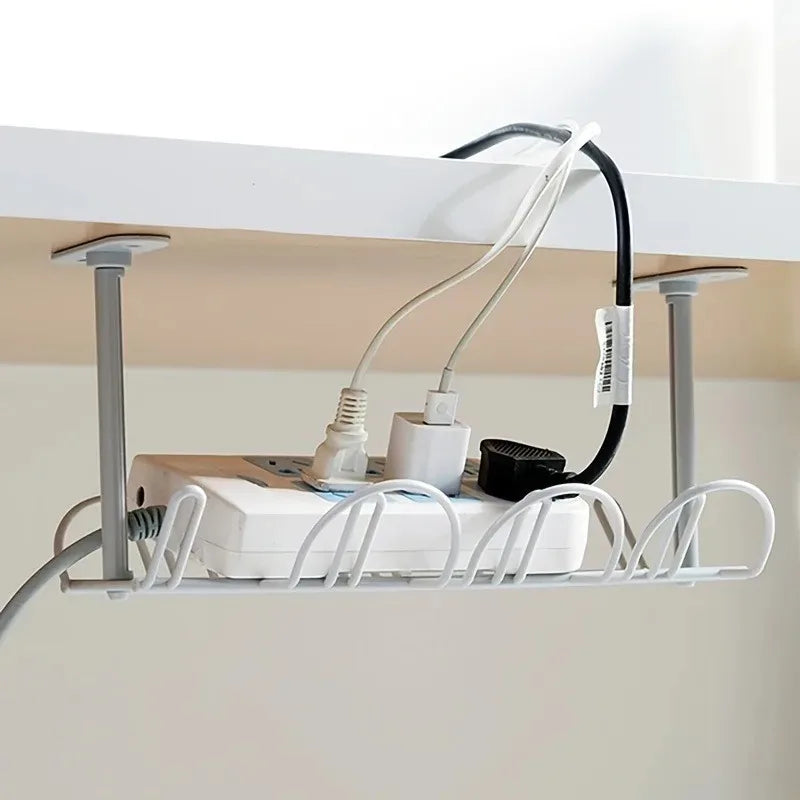 gray under desk cable management tray installed under white desk, organizing cords and a power strip