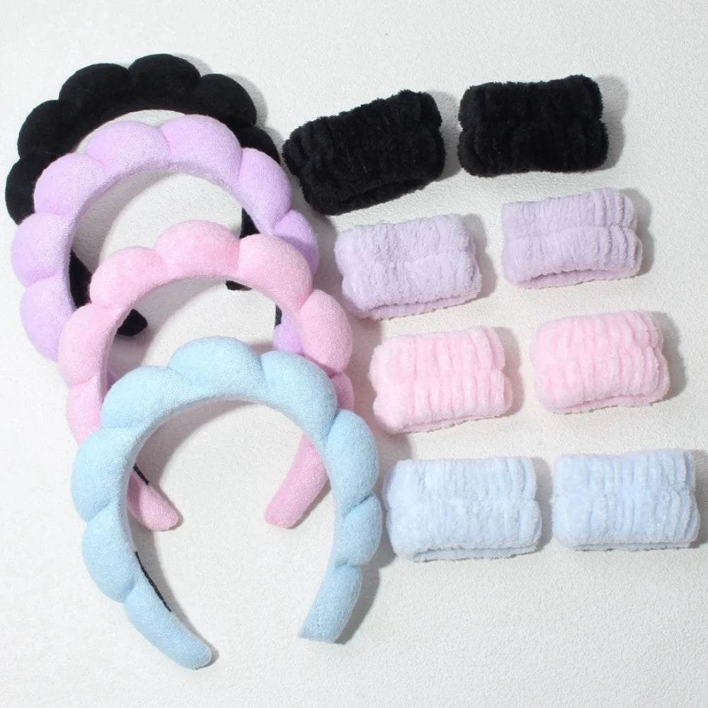 padded headbands and wristbands set in black, purple, pink, and blue color options displayed on a flat surface