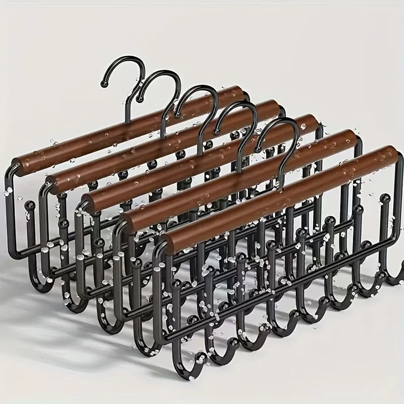 Set of four metal hook hangers with faux wood detailing arranged on a surface
