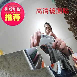 Acrylic mirror wall sticker reflecting a person during application on a flat surface