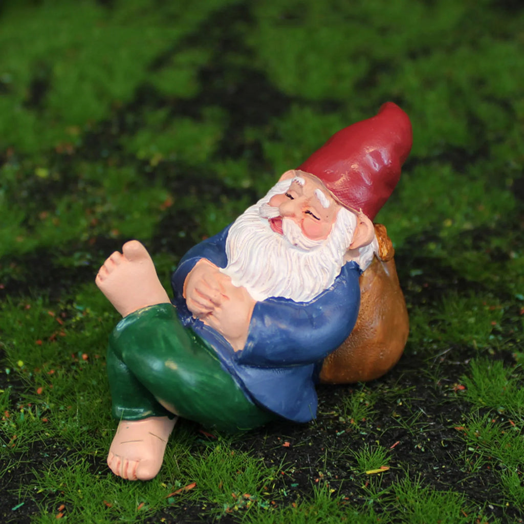 Mini resin garden gnome statue lounging on green grass, perfect for outdoor or shelf decor