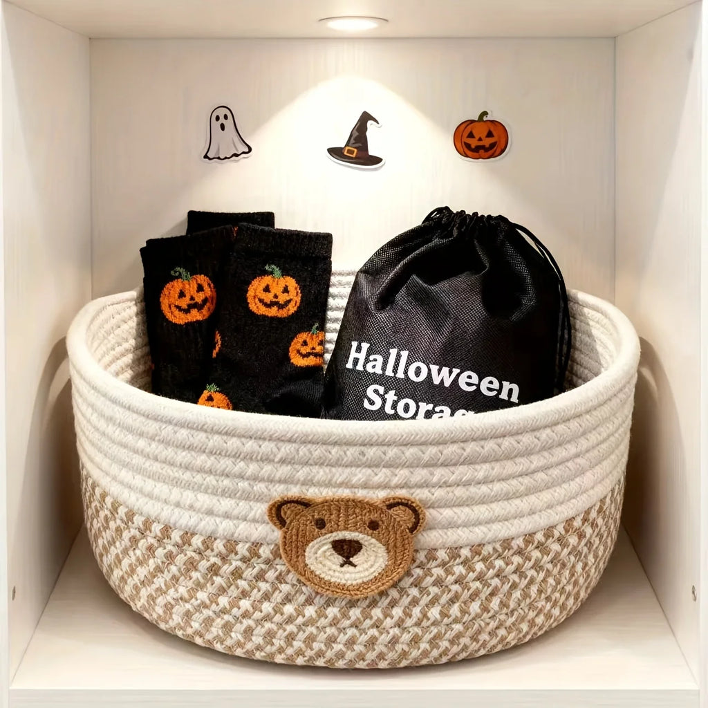 Bear nursery storage basket holding black Halloween-themed socks and a drawstring pouch, displayed on a shelf