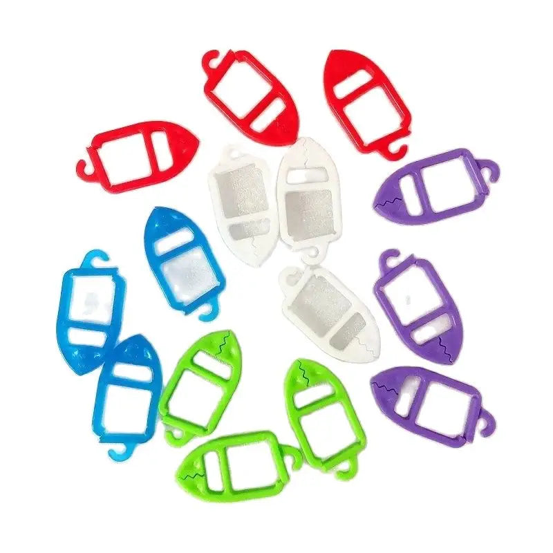 Assorted red, blue, green, purple, and white plastic sock clips arranged in a circle on a white background.