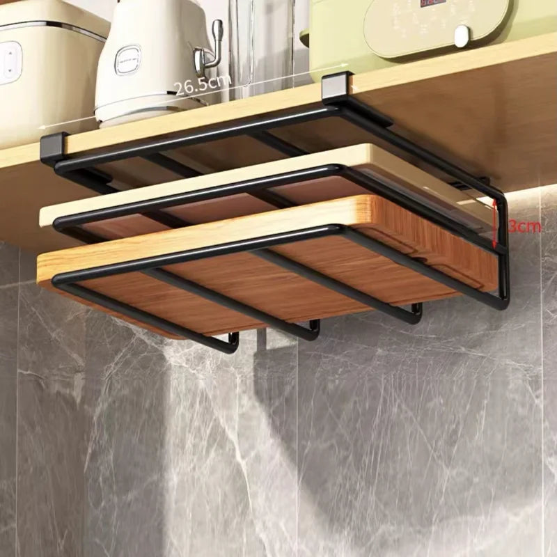 Under cabinet metal storage rack holding cutting boards in a kitchen