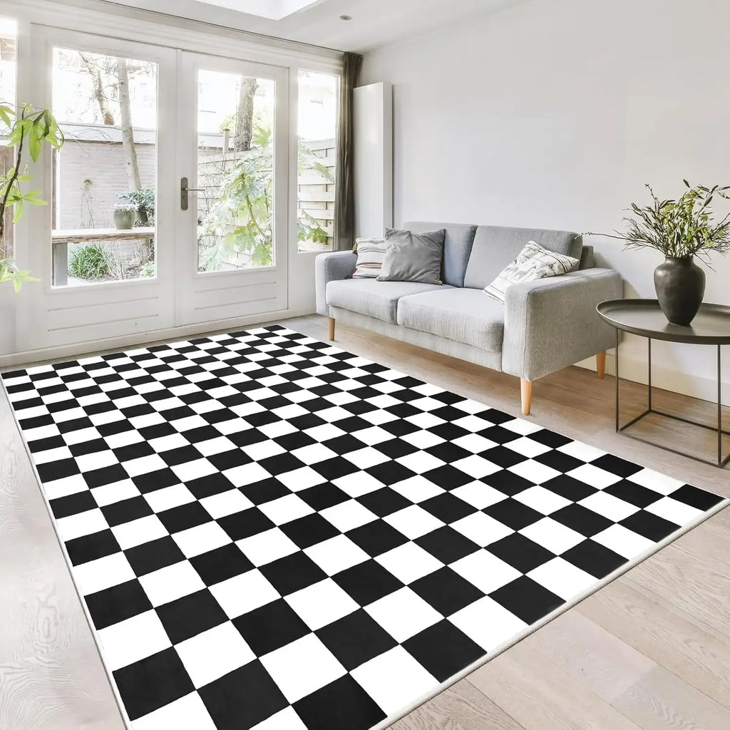 Black and white checkered area rug in a bright living room with gray sofa and coffee table