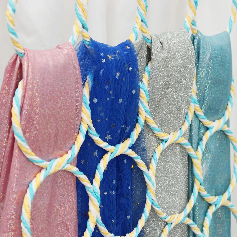 Closeup of pastel blue, yellow, pink rattan-covered loops holding several scarves
