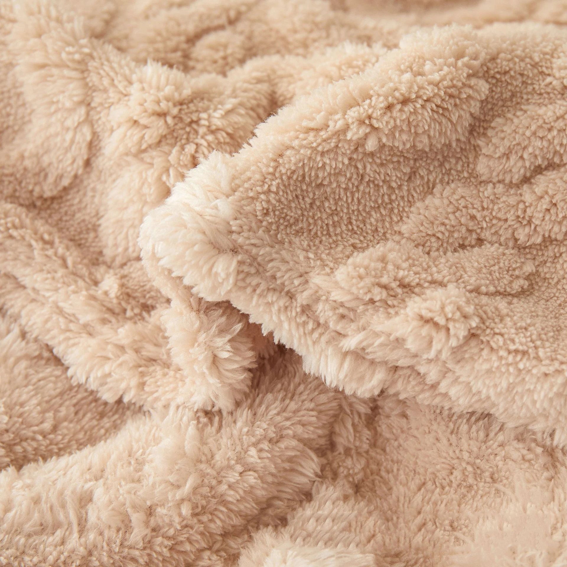 Close-up of soft sherpa fleece texture in beige color