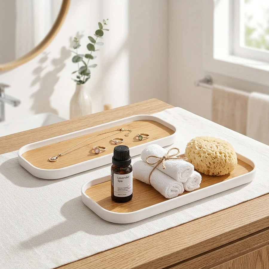 White rim vanity tray holding rolled towels, soap, and jewelry on a bathroom counter