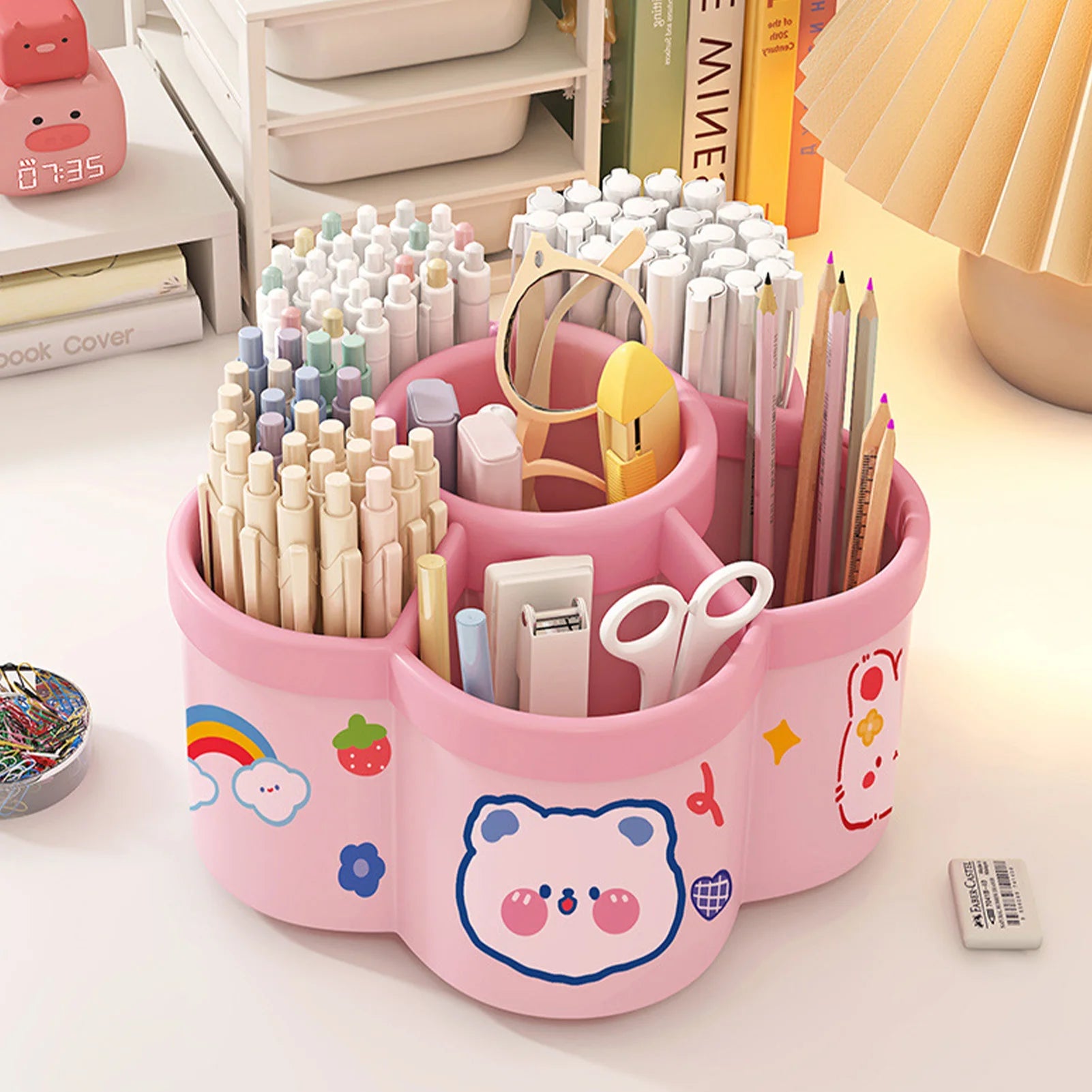 Pink kawaii rotating pen holder organizing art supplies and pens on a desk