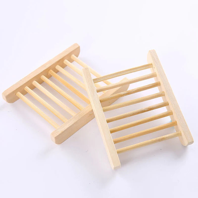Pair of natural wood slatted soap dishes on a white background