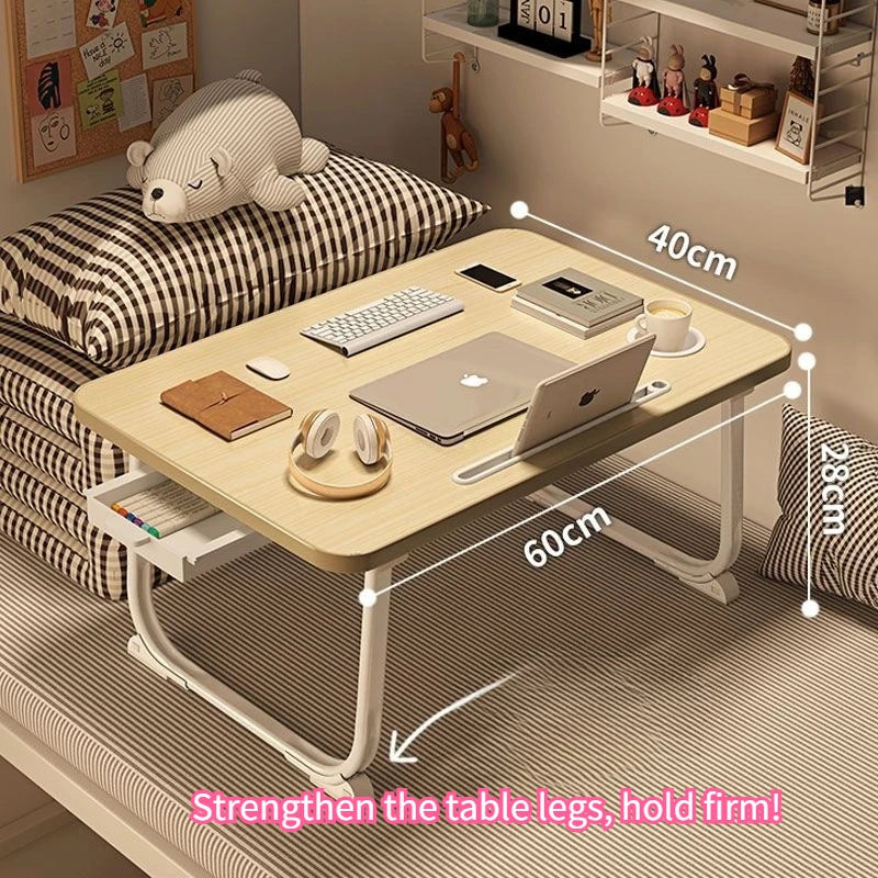 Foldable bedside desk with wood tabletop, white legs, and side drawer placed on a bed; dimensions shown 60cm x 40cm x 28cm