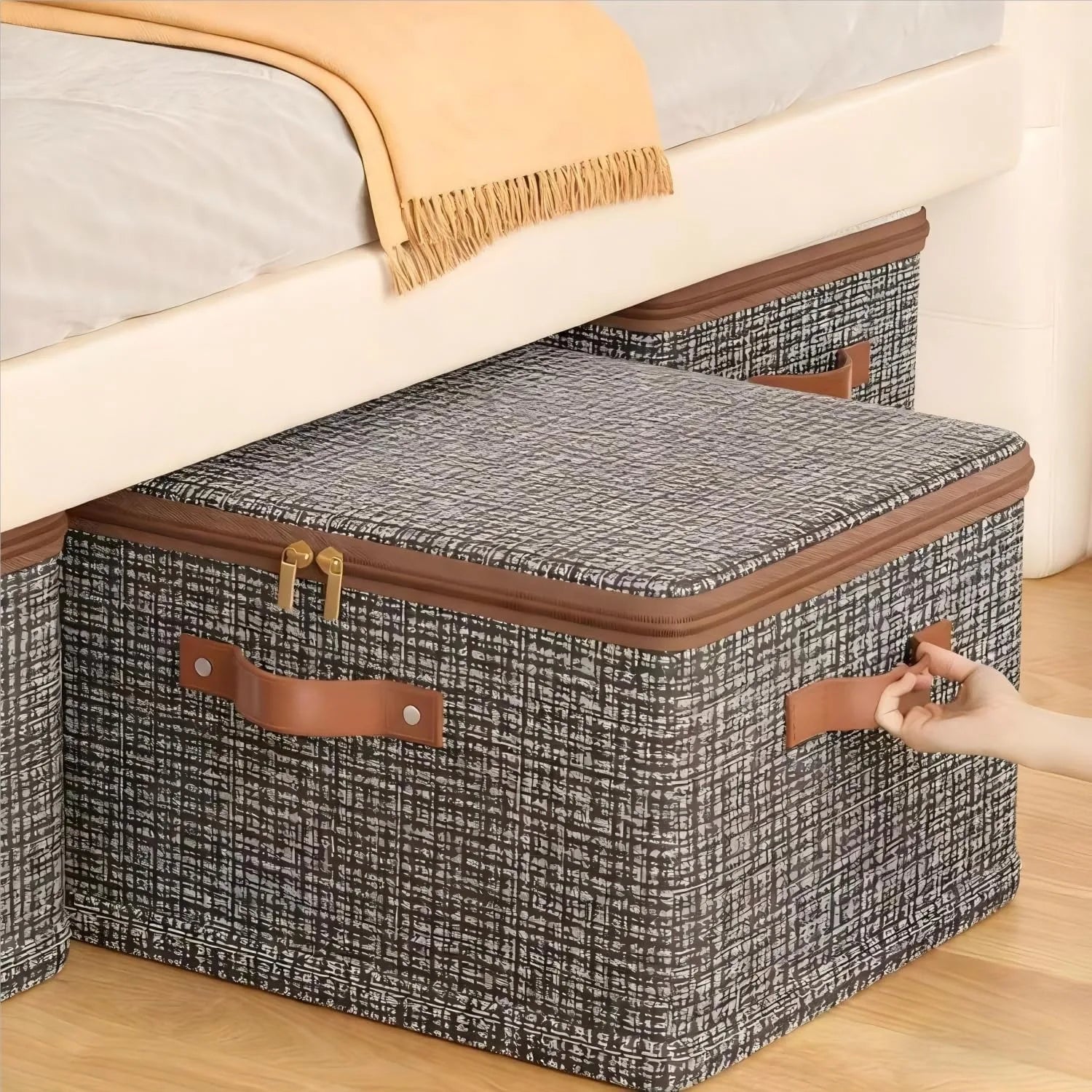 Patterned fabric storage bin with lid and handles shown under a bed for underbed organization