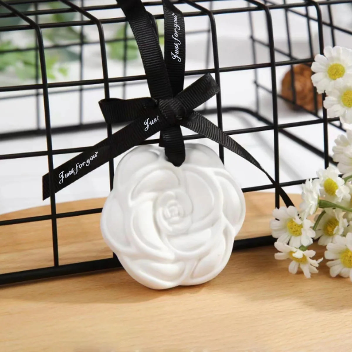 Ceramic camellia scent stone and black ribbon ready for hanging