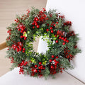 Red berry and evergreen Christmas wreath on white chair, 40cm round