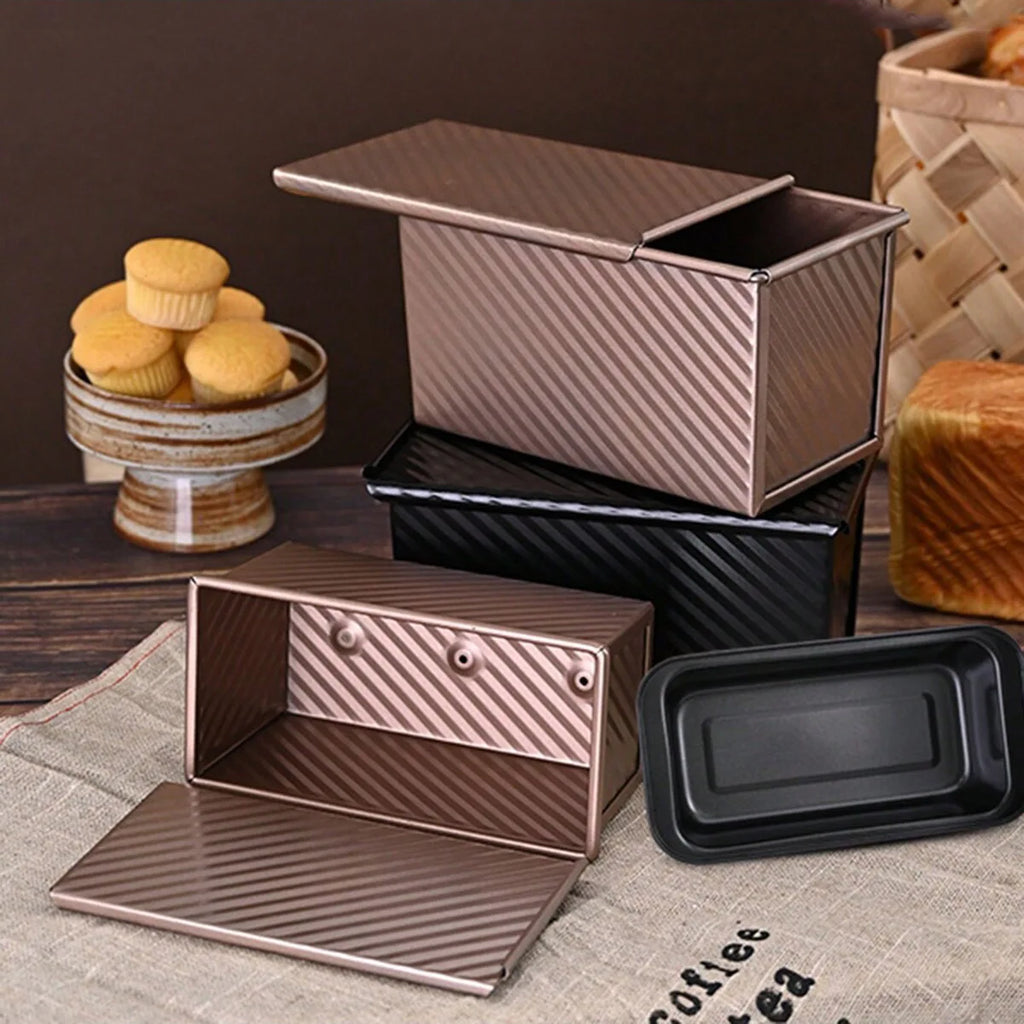 Stacked bread boxes in golden and black, with lids and one loaf inside
