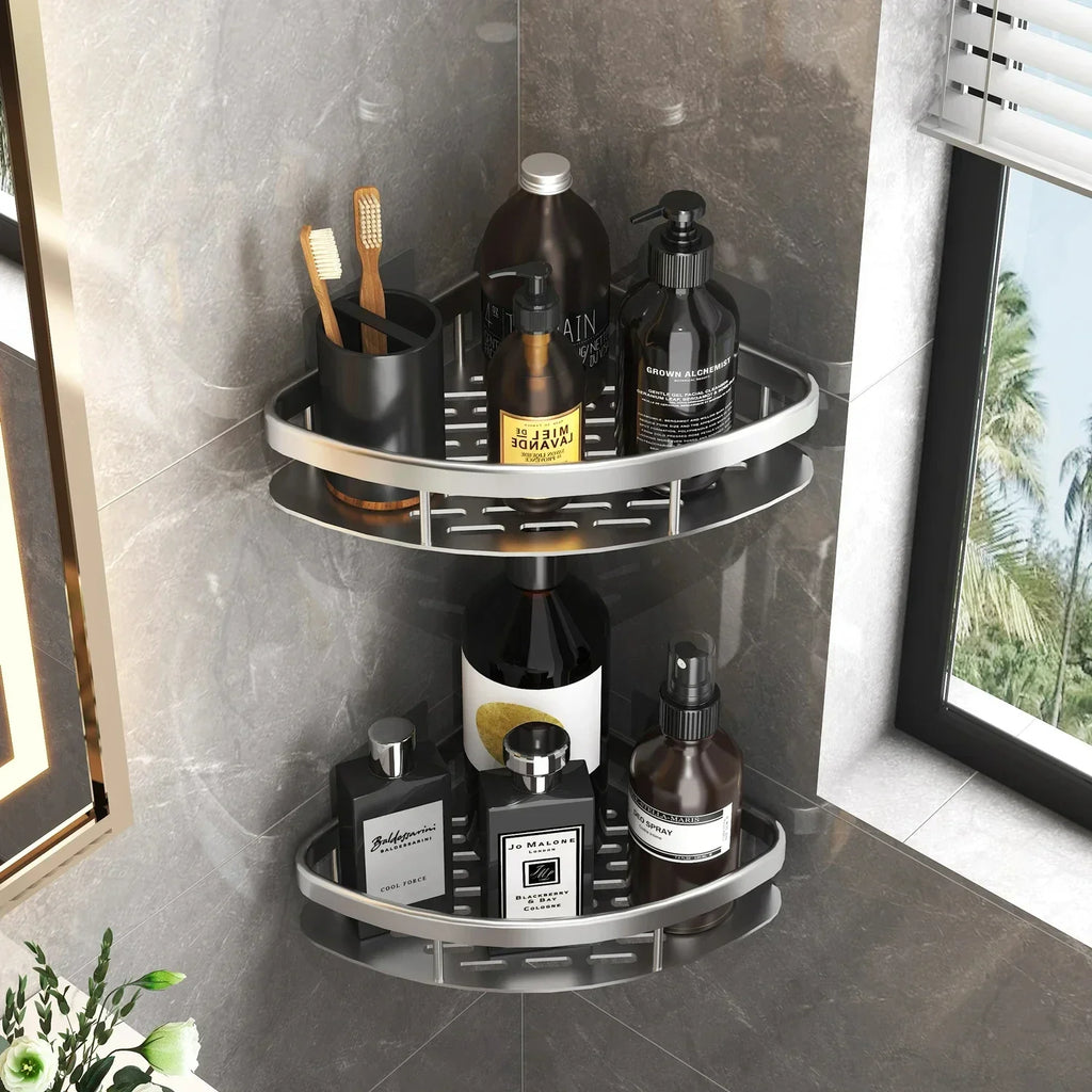 Silvery corner wall-mounted bathroom organizer shelves holding bottles and toothbrushes by a window.