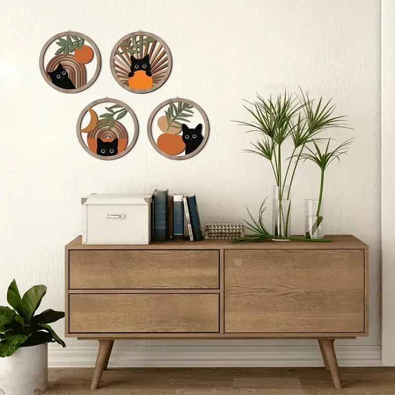 Set of four round cat wooden hangings above a modern wood sideboard with minimalist plants