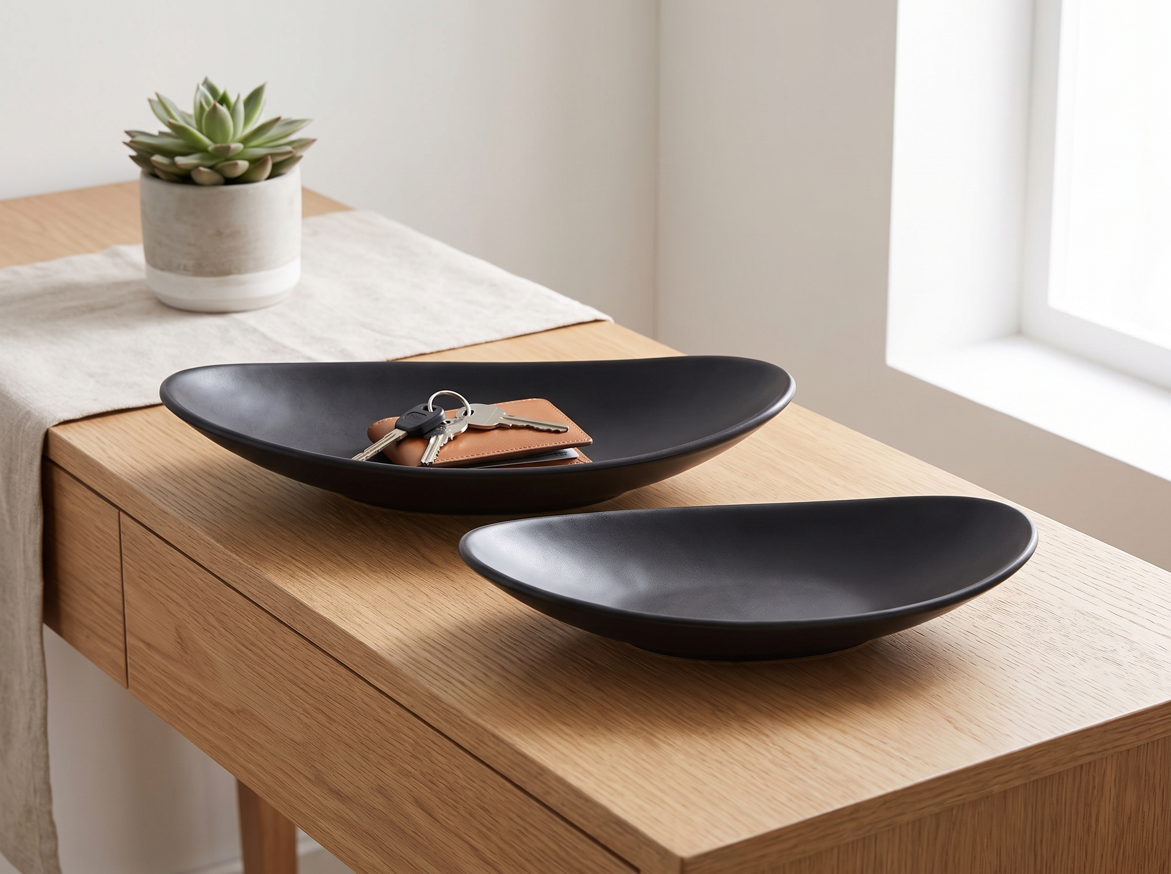 Matte Black Oval Ceramic Tray for Keys, Jewelry, or Everyday Entryway Catch-All in a realistic home setting